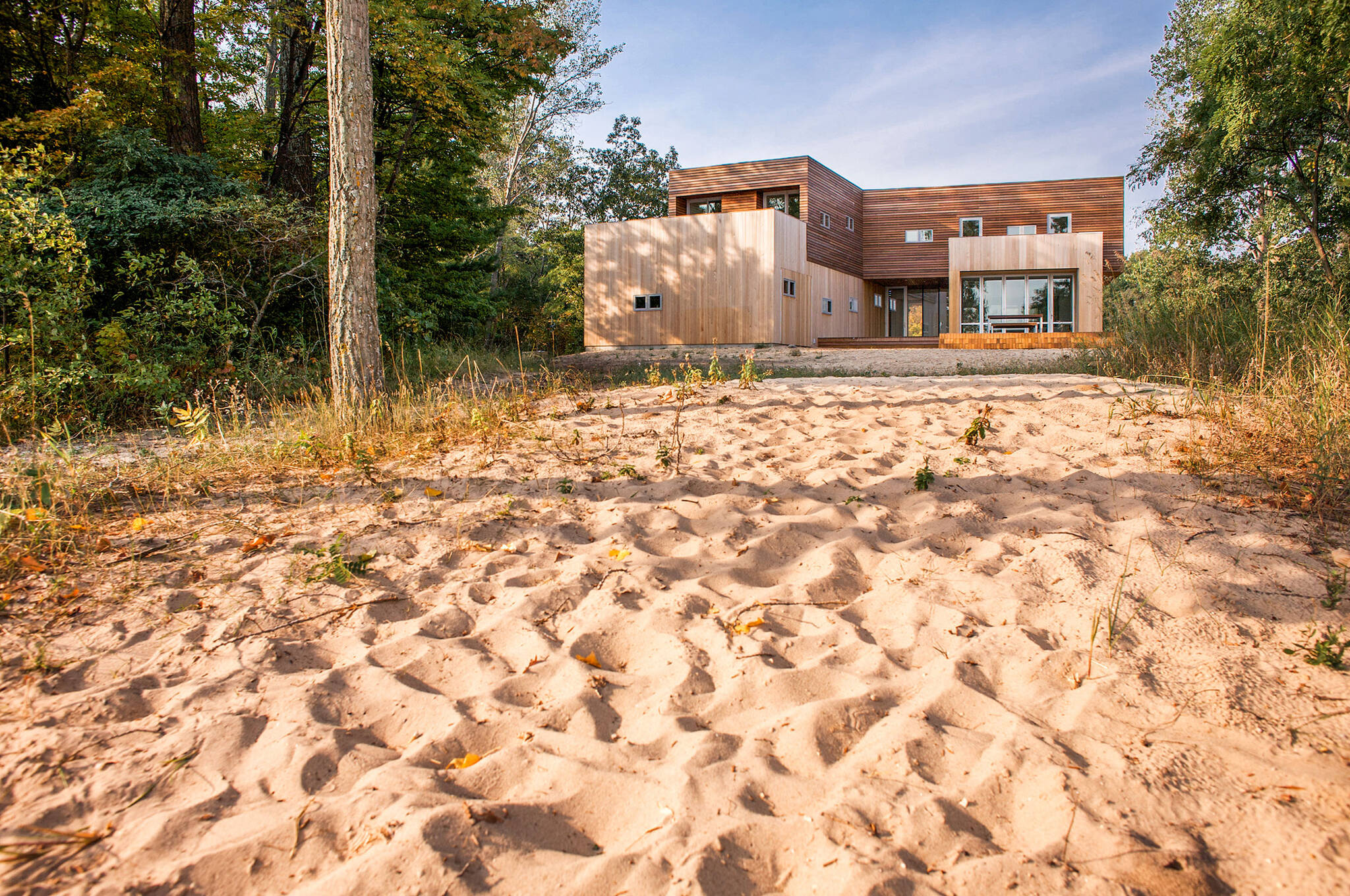 View from the beach of the sustainable lake house project in Omena, Michigan designed by the architecture studio Danny Forster & Architecture