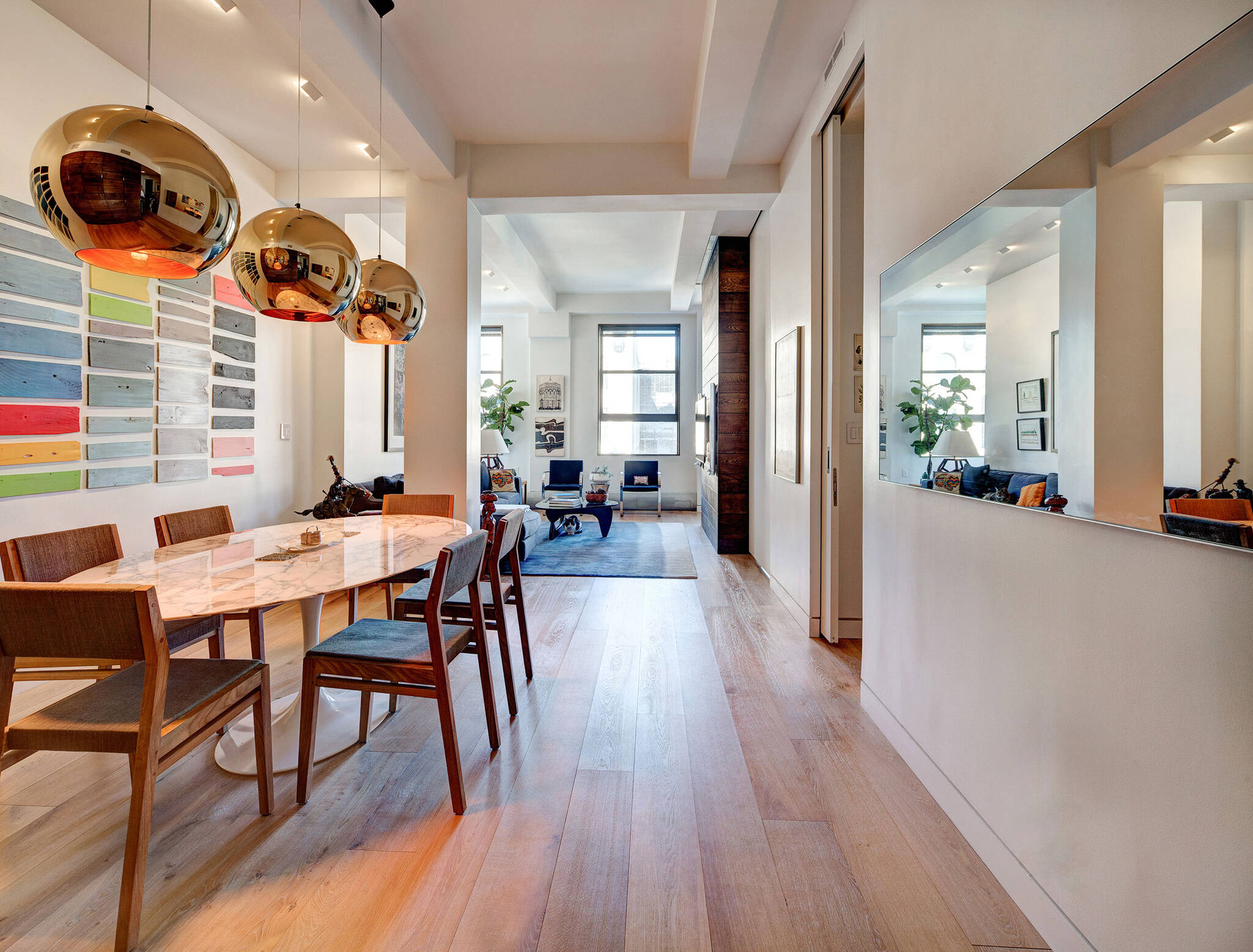 View of the dining room and living room from the entrance of the residence renovation project in the Chelsea Mews building on the Flatiron District in Manhattan, New York City designed by the architecture studio Danny Forster & Architecture