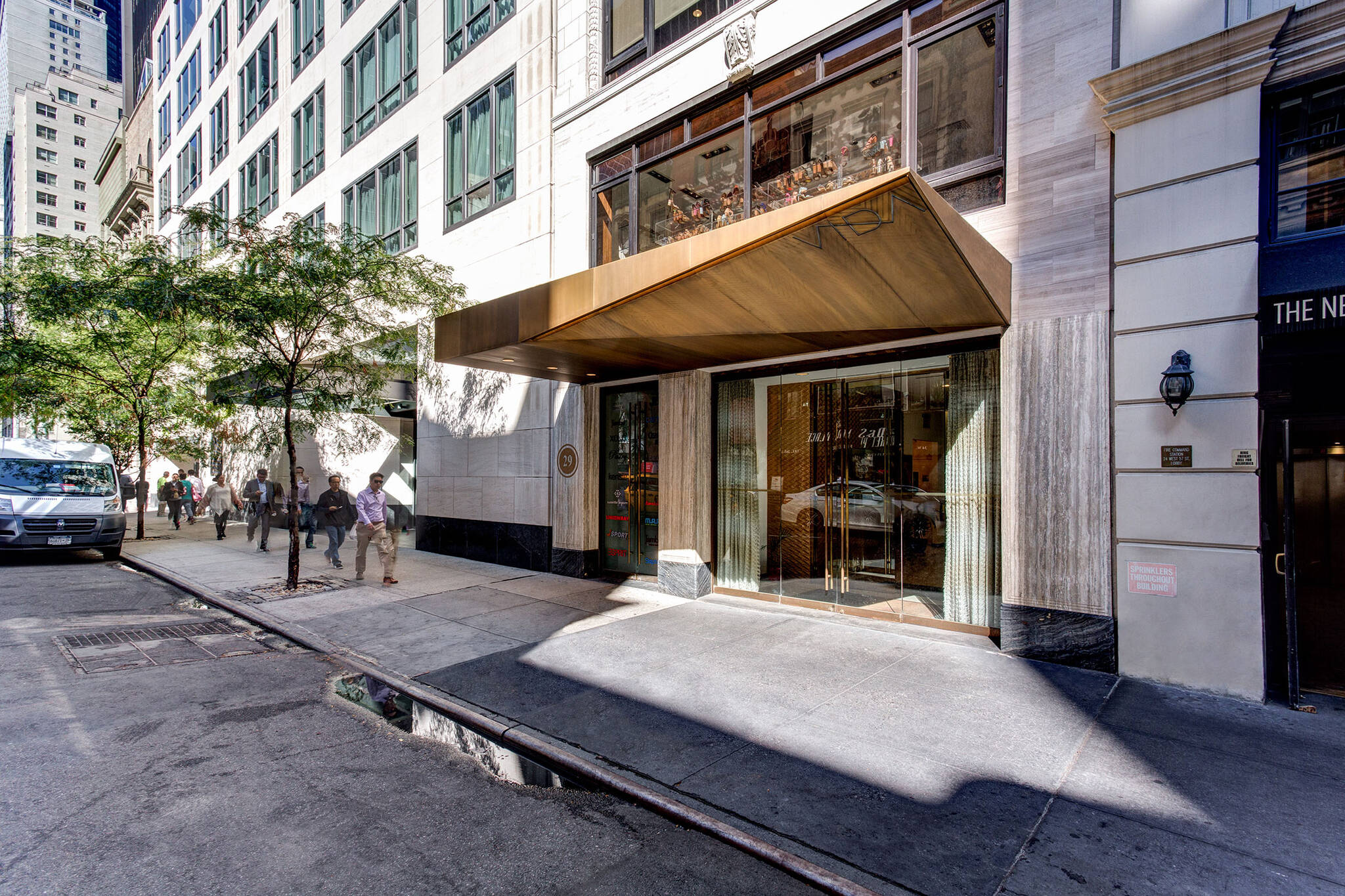 Sidewalk view of the Vida Shoes International canopy project for the shop located at 29 West 56th Street in Midtown, New York City designed by the architecture studio Danny Forster & Architecture